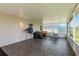 Enclosed patio featuring tile floors, white framed screening and overlooking the fenced backyard at 6351 Desert Peace Ave, Land O Lakes, FL 34639