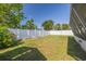 Fenced backyard with ample grass and greenery offers outdoor privacy and space at 6730 10Th Avenue S Ter, St Petersburg, FL 33707