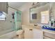 Bathroom features a tub with shower, marble countertop, and open shelving at 6730 10Th Avenue S Ter, St Petersburg, FL 33707