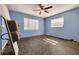 Bright bedroom featuring a ceiling fan and two windows providing natural light at 6730 10Th Avenue S Ter, St Petersburg, FL 33707