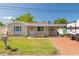 Charming single-story home with a well-maintained lawn, carport, and a brick driveway at 6730 10Th Avenue S Ter, St Petersburg, FL 33707