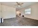Spacious living room with a ceiling fan, bright window, and easy access to the kitchen at 6730 10Th Avenue S Ter, St Petersburg, FL 33707