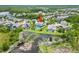 Aerial view of the home's backyard with pool and proximity to a tranquil pond at 8332 Swiss Chard Cir, Land O Lakes, FL 34637