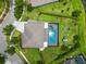 Aerial view of home with pool, lush green yard, and well-manicured landscaping at 8332 Swiss Chard Cir, Land O Lakes, FL 34637