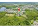 Aerial neighborhood view near wooded area with pond, highlighting home's location at 8332 Swiss Chard Cir, Land O Lakes, FL 34637