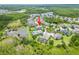 Aerial view shows home's proximity to pond, lush trees, and neighborhood amenities at 8332 Swiss Chard Cir, Land O Lakes, FL 34637