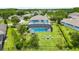 Expansive backyard featuring a screened pool, a play area, and a cozy fire pit, perfect for outdoor living at 8332 Swiss Chard Cir, Land O Lakes, FL 34637