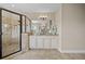 Bathroom with a glass shower, granite countertop vanity, and neutral tile floors at 8332 Swiss Chard Cir, Land O Lakes, FL 34637