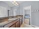 Bathroom with double sinks, granite countertops and view to bedroom at 8332 Swiss Chard Cir, Land O Lakes, FL 34637