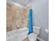 Bathroom features a bathtub and shower with tile surround, along with a toilet at 8332 Swiss Chard Cir, Land O Lakes, FL 34637