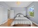 Bedroom with natural light, wood floors and space for a small desk at 8332 Swiss Chard Cir, Land O Lakes, FL 34637
