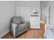 Comfortable bedroom featuring a gray recliner and white dresser against a neutral wall at 8332 Swiss Chard Cir, Land O Lakes, FL 34637