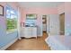 Well-lit bedroom featuring hardwood floors and a white dresser at 8332 Swiss Chard Cir, Land O Lakes, FL 34637