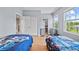 Bedroom features hardwood floors, closet, and views from a large window at 8332 Swiss Chard Cir, Land O Lakes, FL 34637