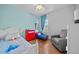 Bright bedroom with Frozen-themed decor, twin beds, blue accent wall and hardwood floors at 8332 Swiss Chard Cir, Land O Lakes, FL 34637