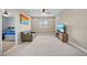 Bonus room featuring carpet, fan, TV, sofa and a peek into the adjacent bedroom at 8332 Swiss Chard Cir, Land O Lakes, FL 34637