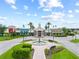 View of the community center with a water fountain, benches, and palm trees at 8332 Swiss Chard Cir, Land O Lakes, FL 34637