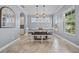 Elegant dining room bathed in natural light, featuring stylish lighting and tile flooring for sophisticated dining at 8332 Swiss Chard Cir, Land O Lakes, FL 34637