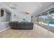 Comfortable living room features tile floors, ceiling fan, and sliding doors leading to the pool area at 8332 Swiss Chard Cir, Land O Lakes, FL 34637