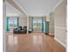 Open living room featuring hardwood flooring, high ceilings, and plenty of natural light at 8332 Swiss Chard Cir, Land O Lakes, FL 34637