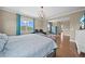 Spacious main bedroom with hardwood floors, sitting area and decorative ceiling fan at 8332 Swiss Chard Cir, Land O Lakes, FL 34637