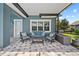 Covered patio with comfortable seating provides a relaxing outdoor space at 8332 Swiss Chard Cir, Land O Lakes, FL 34637