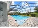 Screened pool and spa with brick patio and playground in the backyard at 8332 Swiss Chard Cir, Land O Lakes, FL 34637