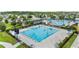 Aerial view of a lap swimming pool with blue and white lane markers, lounge chairs, and a fence at 8332 Swiss Chard Cir, Land O Lakes, FL 34637