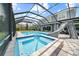 Screened pool and spa with a slide and tiled deck enhance this outdoor oasis at 8332 Swiss Chard Cir, Land O Lakes, FL 34637