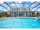Large screened pool with outdoor seating is perfect for enjoying the outdoors at 8332 Swiss Chard Cir, Land O Lakes, FL 34637