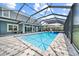 Large screened pool with spa, water slide, and brick deck offers outdoor enjoyment at 8332 Swiss Chard Cir, Land O Lakes, FL 34637