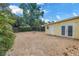 Large brick-paved backyard featuring the side of the house with double doors and ample space at 914 Sandpiper Way S, St Petersburg, FL 33707