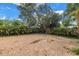 Expansive backyard with brick pavers and a privacy fence surrounded by mature landscaping at 914 Sandpiper Way S, St Petersburg, FL 33707