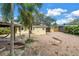 Spacious backyard featuring brick pavers, a covered seating area, and tropical landscaping at 914 Sandpiper Way S, St Petersburg, FL 33707