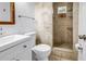 Bathroom with tiled walk-in shower, updated vanity, and modern fixtures at 914 Sandpiper Way S, St Petersburg, FL 33707