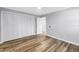 Bedroom features wood-look floors, large closet, and fresh neutral paint at 914 Sandpiper Way S, St Petersburg, FL 33707