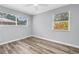 Bright bedroom with windows, wood-look floors, and a ceiling fan at 914 Sandpiper Way S, St Petersburg, FL 33707