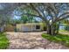 Charming yellow single-story home with a brick driveway and large shade tree in the front yard at 914 Sandpiper Way S, St Petersburg, FL 33707