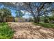 Charming yellow single-story home with a brick driveway and a large shade tree in the front yard at 914 Sandpiper Way S, St Petersburg, FL 33707
