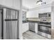 Bright kitchen features stainless steel appliances, white cabinets, and modern countertops at 914 Sandpiper Way S, St Petersburg, FL 33707