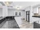 Open kitchen layout with bar seating area, stainless refrigerator, and modern finishes at 914 Sandpiper Way S, St Petersburg, FL 33707