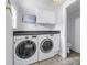 Convenient laundry room with washer, dryer, storage, and tiled flooring at 914 Sandpiper Way S, St Petersburg, FL 33707
