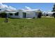 Well-maintained backyard with a lush lawn, and white house with awning at 9218 40Th N Way, Pinellas Park, FL 33782