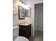 Cozy bathroom featuring a dark wood vanity, marble countertop, and framed mirror at 9218 40Th N Way, Pinellas Park, FL 33782