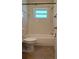 Bright bathroom featuring a tub and tiled surround, paired with wood-look flooring at 9218 40Th N Way, Pinellas Park, FL 33782
