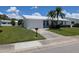 Well-maintained single-story home with a lush green lawn and attractive landscaping at 9218 40Th N Way, Pinellas Park, FL 33782