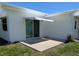 Exterior of the home with a concrete patio and retractable awning at 9218 40Th N Way, Pinellas Park, FL 33782