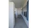 Covered porch with brick columns and blue shutters creating a welcoming entrance at 9218 40Th N Way, Pinellas Park, FL 33782