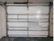 Interior view of a white sectional garage door in need of maintenance at 9218 40Th N Way, Pinellas Park, FL 33782
