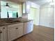 Updated kitchen featuring granite countertops, white appliances and cabinetry, with laminate floors at 9218 40Th N Way, Pinellas Park, FL 33782